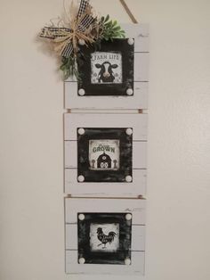 three framed pictures hanging on the wall with a bow and ribbon attached to each one