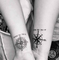 two people holding hands with tattoos on their wrists and compass tattoo designs on their wrist