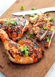 the chicken is cut up and ready to be served on the cutting board with a knife