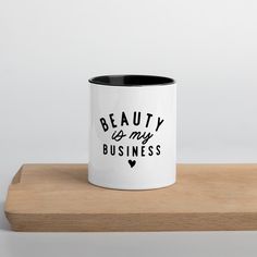 a white and black coffee mug with the words beauty is my business on it