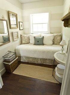 a bedroom with a white bed and pillows