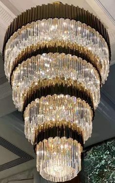 a large chandelier hanging from the ceiling in a room with many lights on it