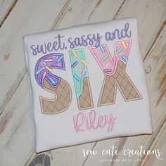 a white shirt with the words sweet sassy and sask riley on it sitting on a wooden surface