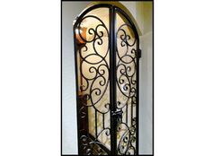 an ornate iron door with glass panels on the front and side doors are shown in black