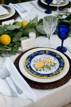 the table is set with plates and place settings