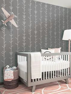 a baby's room with an airplane painted on the wall and a crib