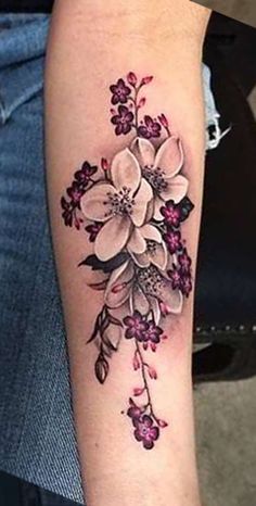 a woman's arm with flowers on it