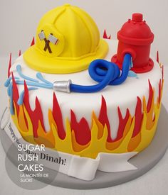 a birthday cake with a fireman's hat and hose