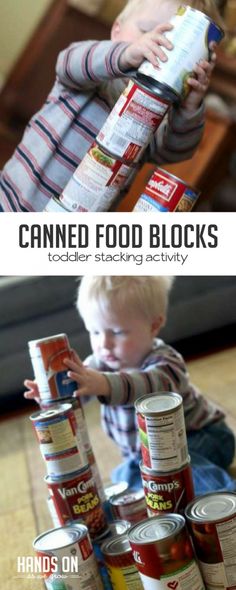 a toddler playing with canned food and stacking it on top of each other