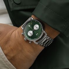 Inspired by the rebellious spirit of 1960âs auto culture, this chronograph dial nods to the look and feel of muscle car dashboards, with double-domed glass, triple sub-dials and slick polished metals. Featuring a deep green and silver colorway pulled from vintage car paint shades. Green Watch With Polished Finish And Round Dial, Classic Green Chronograph Watch With Analog Display, Timeless Green Chronograph Watch With Analog Display, Luxury Green Chronograph Watch With Analog Display, Green Modern Watches With Subdials, Timeless Green Chronograph Watch With Subdials, Modern Green Chronograph Watch, Modern Green Chronograph Watch With Tachymeter, Modern Green Chronograph Watch With Analog Display