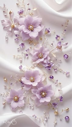 purple flowers and pearls on white fabric