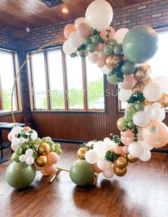 balloons and greenery are arranged on the floor