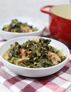 two white bowls filled with food on top of a checkered table cloth