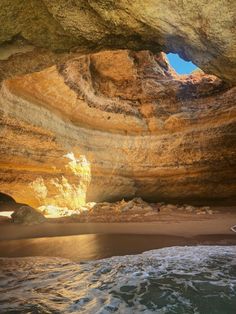 the inside of a cave with waves coming in