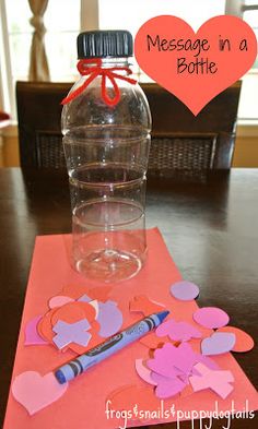 a bottle filled with hearts sitting on top of a table next to paper cutouts