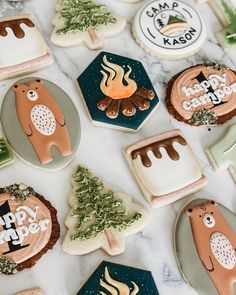 decorated cookies with frosting and icing on a marble countertop in the shape of bears