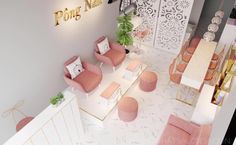 an aerial view of a restaurant with pink chairs and white walls, gold lettering on the wall