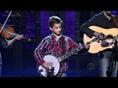 two young men are playing instruments on stage