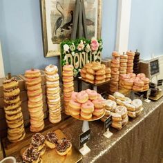 a table topped with lots of donuts and pastries