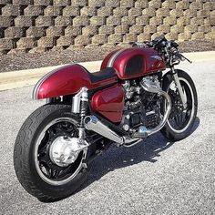 a red motorcycle is parked on the street