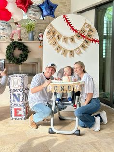 a family poses for a photo in front of their baseball themed birthday cake