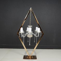 a crystal and brass chandelier with candles in the shape of an octagon