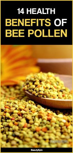 a wooden spoon filled with bee pollen on top of a table