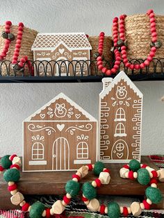 gingerbread houses are decorated with red, green and white beads for the holiday season