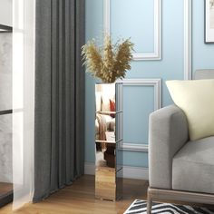 a living room with blue walls and white curtains