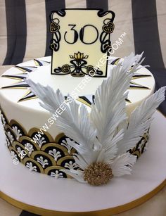 a white and black cake with gold accents