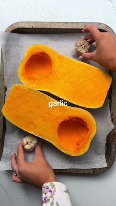 someone is peeling the inside of a butternut squash on a baking sheet with their hands