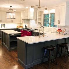 a kitchen with an island and two stools