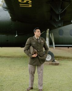 a man standing in front of an airplane