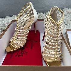 Brand New - Never Worn (Given As A Gift) With Original Box And Dust Bag - Authentic Heels Millaclou Studded-Cage Red Sole Sandal, Edelweiss/Gold Christian Louboutin - Women's Size 39 (Us Size 8.5) Millaclou Studded-Cage Red Sole Sandal, Edelweiss/Gold Christian Louboutin Kid And Napa Leather Sandal. 4" Metallic Golden Heel. Metallic Knotted T-Strap. Stud-Caged Upper. Golden Hardware. Back Zip Eases Dress. Signature Red Leather Outsole. "Millaclou" Is Made In Italy. Designer White Heels For Party, Christian Louboutin Women, Caged Heels, Louboutin Heels, Christian Louboutin Heels, Red Sole, White Outfits, T Strap, Christian Louboutin Shoes