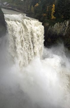 a large waterfall with water pouring over it