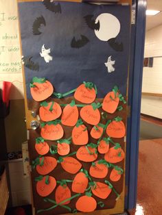 a door decorated with pumpkins and writing on it