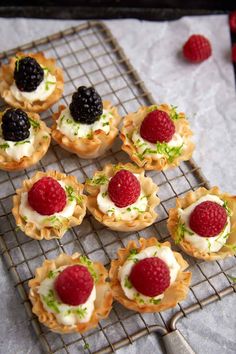 small desserts with raspberries and cream on a cooling rack