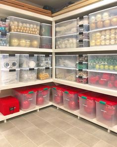 an organized pantry with plastic containers and bins on the shelves, full of fruits and vegetables