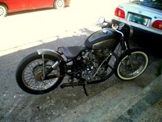 a black motorcycle parked next to a car