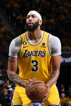 a man holding a basketball in his right hand and wearing a white hat on top of it