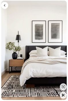 a bedroom with two pictures above the bed and an area rug on the floor next to it