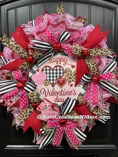 a valentine's day wreath with leopard print, pink and black ribbons and hearts