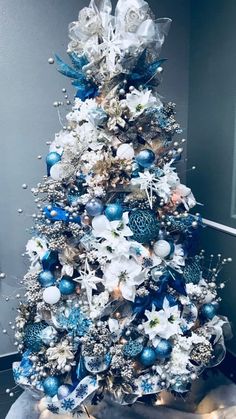 a blue and white christmas tree with ornaments