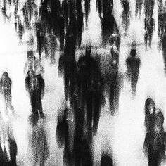 black and white image of people walking down the street