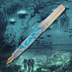 a fountain pen sitting on top of a blue and green background with an underwater scene