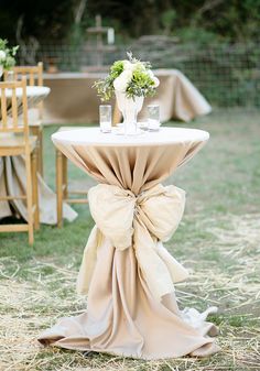 a table with a bow on it in the grass