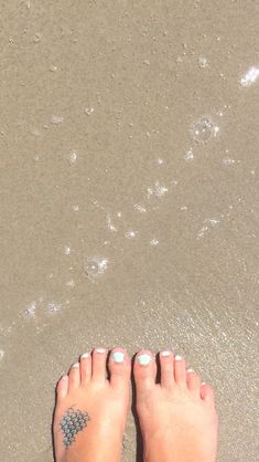 someone's feet in the sand with their tattoos on them and text that reads, beautiful ocean tattoos