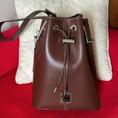 New. Rare. Vintage. Authentic D&B From Toiny Collection. 100% Leather. Beautiful & Structured. Made In Usa. Leather Lined. Brass Hardware. 4 Metal Feet. Shoulder Drop 12.5". Leather String Closure With Metal Stopper. Please Check Photos/Video As It Form Detailed Description Of The Item. Elegant Tan Bucket Bag For Travel, Classic Tan Bucket Bag For Travel, D B, Dooney & Bourke Bags, Brass Hardware, Dooney Bourke, Leather Bag, Made In Usa, Bag Lady