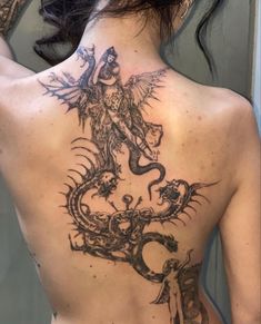 a woman with a dragon tattoo on her back