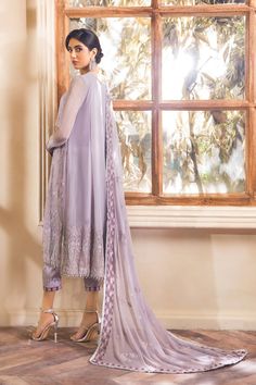 Lavender Pakistani Dress with Fine Embroidery a meticulously made Pakistani Dress. This Pakistani Salwar Kameez comes in eye-catching decorations and a perfect soothing shade of this Pakistani Dress catches attention at the very first glance making you the center of the circle. Kameez: This Pakistani Dress comes with a beautiful Long Kameez. This kameez is perfectly adorned with fine embroidery work, tilla, and iridescent sequins. The delicate neckline of this Pakistani Chiffon Dress and the ski Party Dress Pakistani, Lavender Party Dress, Pastel Purple Color, Lavender Party, Dresses Asian, Fine Embroidery, Asian Designers, Pakistani Salwar, Embroidery Online